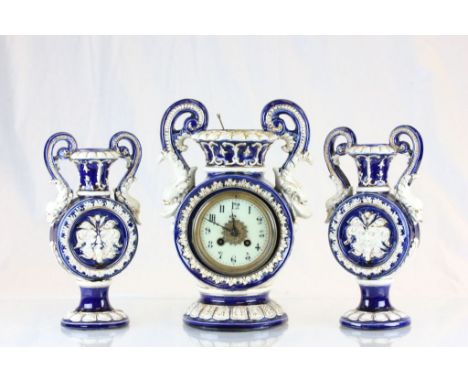 Late 19th Century Continental ceramic clock garniture with dolphin handles