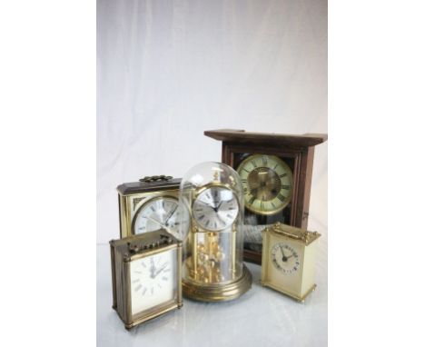 Antique two train mantle clock,an anniversary clock and two others.
