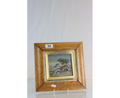 Maple framed & glazed tapestry of a regency figure reclining with dogs