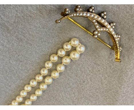A yellow metal seed pearl encrusted semi-circular brooch plus a long single string of pearls with an Art Deco clasp, possibly