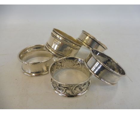 Five sterling silver napkin rings. 