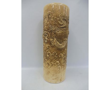 A tall Bretby pottery stick stand decorated with dragons in relief, 24 1/2" high. 