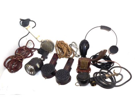 A pair of Bakelite walkie-talkie microphones, a tape recorder microphone marked Mikr-Tel, three hand-held microphones (one ma