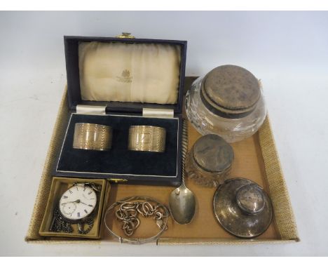A tray of silver to include a cased pair of napkin rings, bracelets, an inkwell etc. 