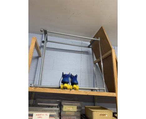 A pair of roller boots and a clothes rail