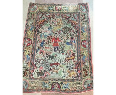 HUNTING KIRMAN BORDERED PRAYER RUG, decorated with two central figures, groups of wild animals and stylised plants, the borde