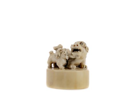 EARLY 20TH CENTURY CHINESE IVORY SEAL, modelled with a foe dog and pup, carved, 5cm wide Provenance: A Private Scottish Colle