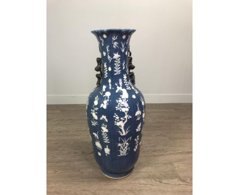 19TH CENTURY CHINESE VASE, decorated with flowers in relief in white enamel in a blue ground, incised four character mark to 