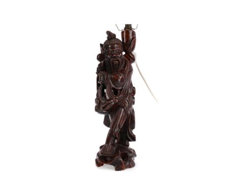 EARLY 20TH CENTURY CHINESE CARVED ROOTWOOD FIGURAL LAMP, modelled in the form of a man, 50cm high to light fitment
