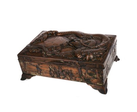 EARLY 20TH CENTURY CHINESE COPPER CASKET, of rectangular form, the hinged lid with a dragon and mountain in relief, the sides