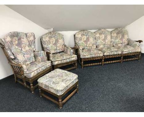 A four piece Ercol lounge suite comprising of settee, two armchairs and footstool