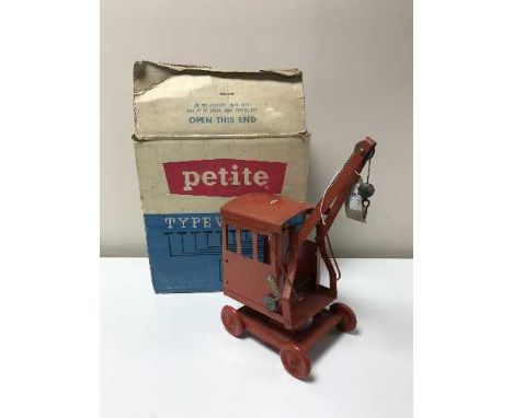 A boxed Petite Typewriter together with a vintage Triang tin plate crane
