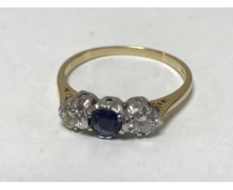 An 18ct gold three stone diamond and sapphire ring