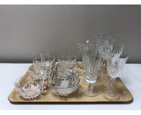 Two trays containing a large quantity of lead crystal and glassware including grapefruit bowls, candlestick, wine glasses, sh