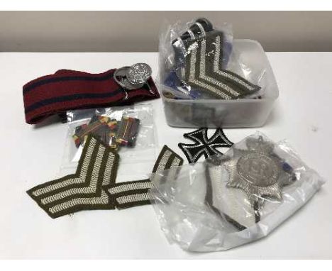 A collection of army rank badges, insignia etc
