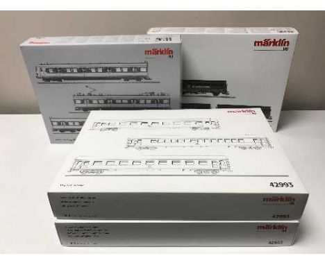 Three Marklin rail car packs, 37504, 42993, 42953, together with a stake car set 46921, all HO scale, all parts boxed.