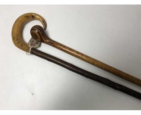 A horn-handled walking stick, together with a pommel-handled walking stick.  (2) 