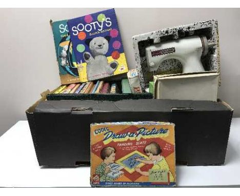 A box of Jones Meccano lockstitch sewing machine together with vintage annuals and games 