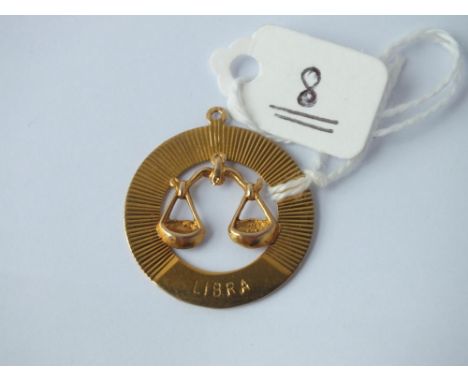 A 9ct pendant with the scales of justice “Libra”    