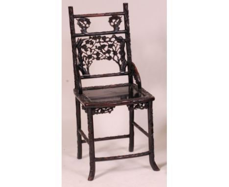 A 19th century Chinese carved 'rosewood' panel seat chair, the back carved with flowering bamboo, the dish seat with raised d