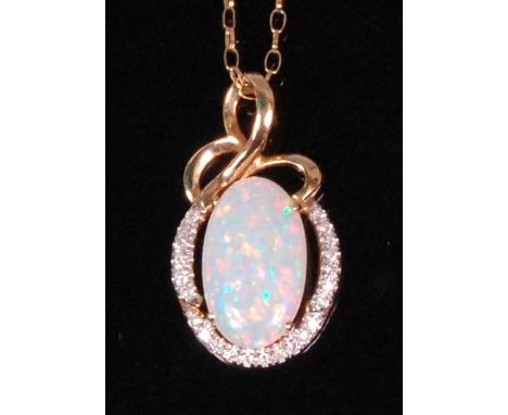 A contemporary 14ct gold opal and diamond set pendant, arranged as a centre oval cabochon opal weighing approx. 2.1ct, in a s