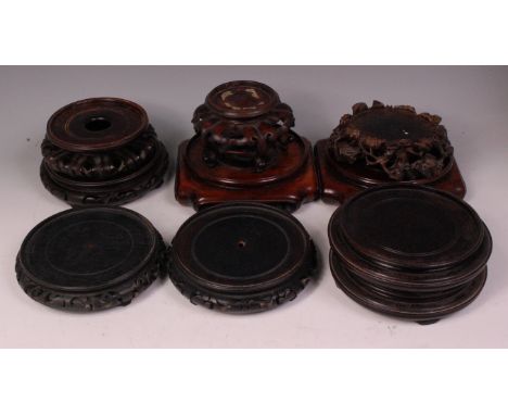 A collection of Chinese hardwood and 'rosewood' vase stands, to include pair of low examples on square bases, lotus type exam