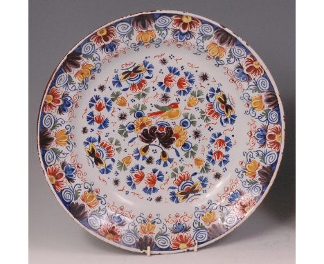 An 18th century Dutch Delft charger, probably from the De Drye Clocken factory, polychrome decorated with a central bird with