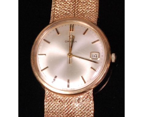 A 1960s gents Omega 9ct gold cased bracelet watch, having a signed silvered dial with baton markers, date aperture and manual