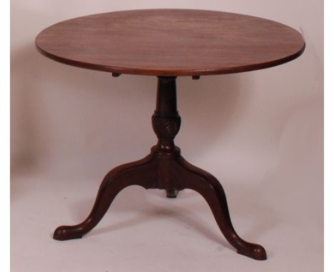 A George III mahogany pedestal tripod table, the one piece circular tilt-top on a gun barrel and spiral fluted urn column, di