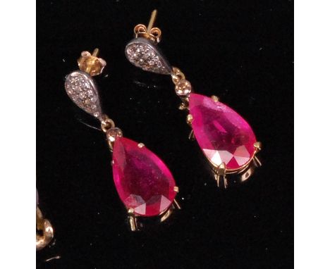 A pair of ladies silver gilt ruby and diamond ear pendants, each pear cut ruby weighing approx. 5ct, on rose cut diamond set 