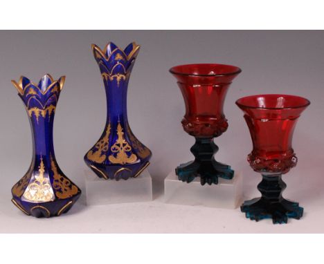 A pair of late 19th century Bohemian blue glass vases, of waisted hexagonal form, with gilt enamel decoration, h.19cm; and on