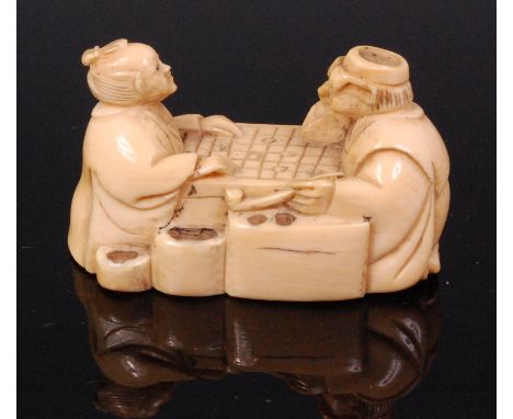 A Japanese carved ivory netsuke of Go players, signed Gyokusho, Meiji period, 4.5cm