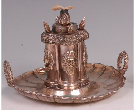 A William IV silver table lighter, having a centre four column reservoir, each column with male mask, flaming torch, and with