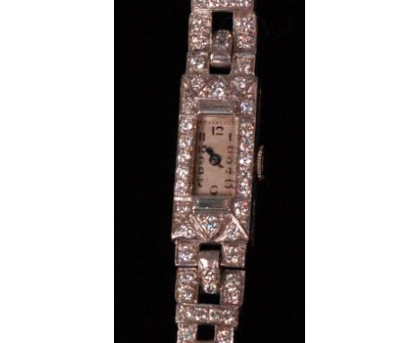A ladies Art Deco white metal and diamond set cocktail watch, having manual wind movement, the case set with brilliant and ba