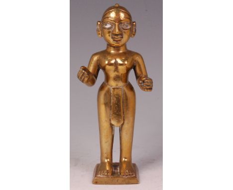 An Indian heavy brass shrine deity figure of Radha, in standing pose, having enamel porcelain eyes and plaited hair, h.18cm C