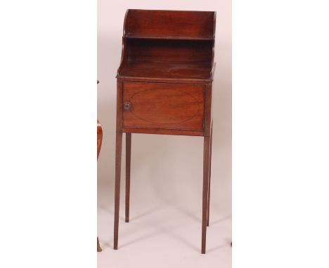 An early 19th century mahogany night table, having a three quarter tiered gallery with single shelf and ebony strung door, w.