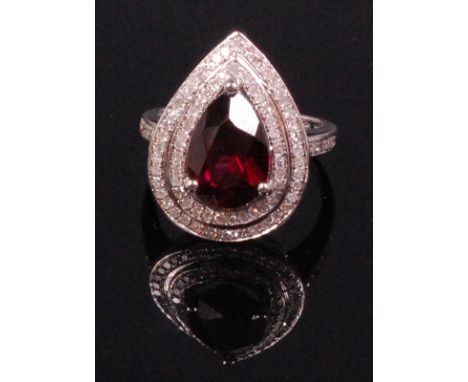 A contemporary 14ct gold pink tourmaline and diamond set dress ring, the pear cut tourmaline weighing approx 4ct within a two