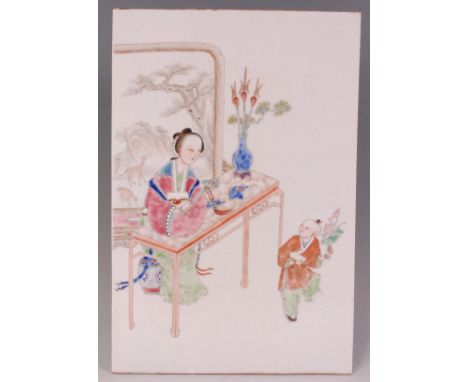 A Chinese famille rose porcelain plaque, enamel decorated with a seated maiden at a table before a screen observing a small b