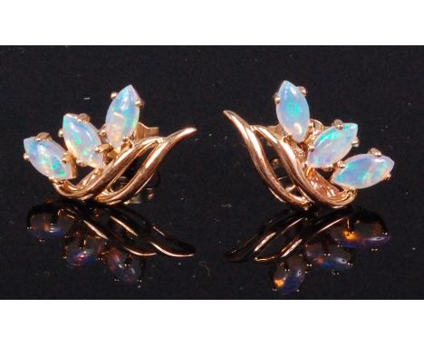 A pair of contemporary 14ct gold opal set ear studs, each with three four claw set opals in a stylised flower head setting, 1