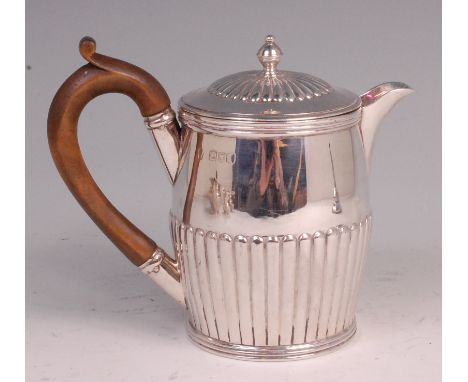 A late Victorian silver hot water pot, of half-reeded barrel shape, having finial topped dome cover, 10.9oz, makers mark worn