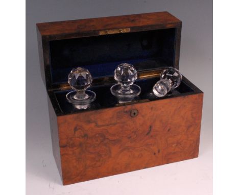 A Victorian figured walnut decanter box, the hinged cover having inset monogrammed brass plaque, opening to reveal velvet lin