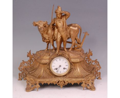 A 19th century French gilt metal mantel clock, the case signed Trouillard and surmounted with a gentleman farmer with his ox 