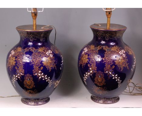 A pair of continental soft paste porcelain vases (later fitted and converted into table lamps), with silk shades but not dril