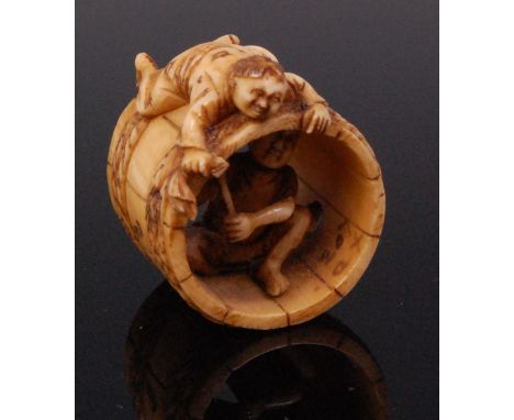 A Japanese carved ivory netsuke of barrel-makers, with penwork decoration, red seal signature verso, Meiji period, 3.5cm Cond