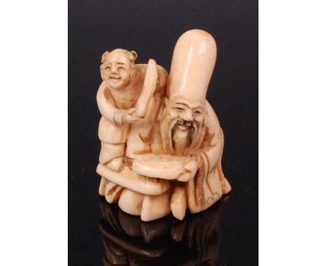 A Japanese carved ivory netsuke of Fukurokuju with attendant, signed verso, Meiji period, h.5cm