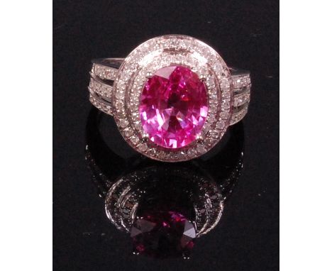 A contemporary 14ct white gold pink sapphire and diamond set ladies dress ring, the oval cut sapphire weighing approx. 3ct, i