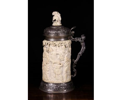 A Large Augsberg Silver Mounted Ivory Tankard of fine quality. The ivory body richly carved in relief with a continuous alleg