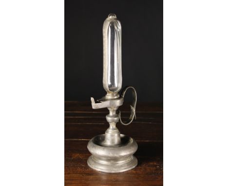 A 19th Century Pewter Oil Lamp Clock, 14 ins (36 cm) in height.