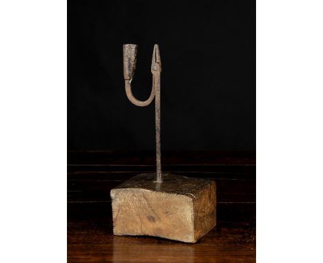 An 18th Century Wrought Iron West Country Rush Light with later base, 11½ ins (29 cms) in height.