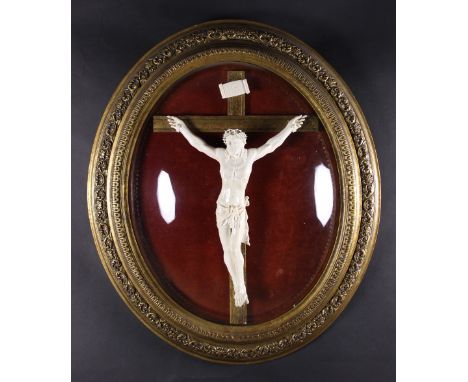 A Large 19th Century Framed Ivory-Glazed Ceramic Crucifix: Christ depicted with an intricately detailed crown of thorns hangi